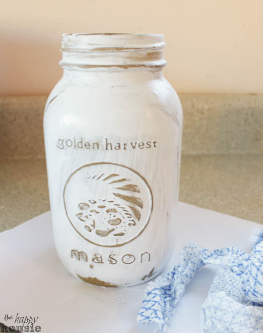 The mason jar with the white paint and some gold being distressed.