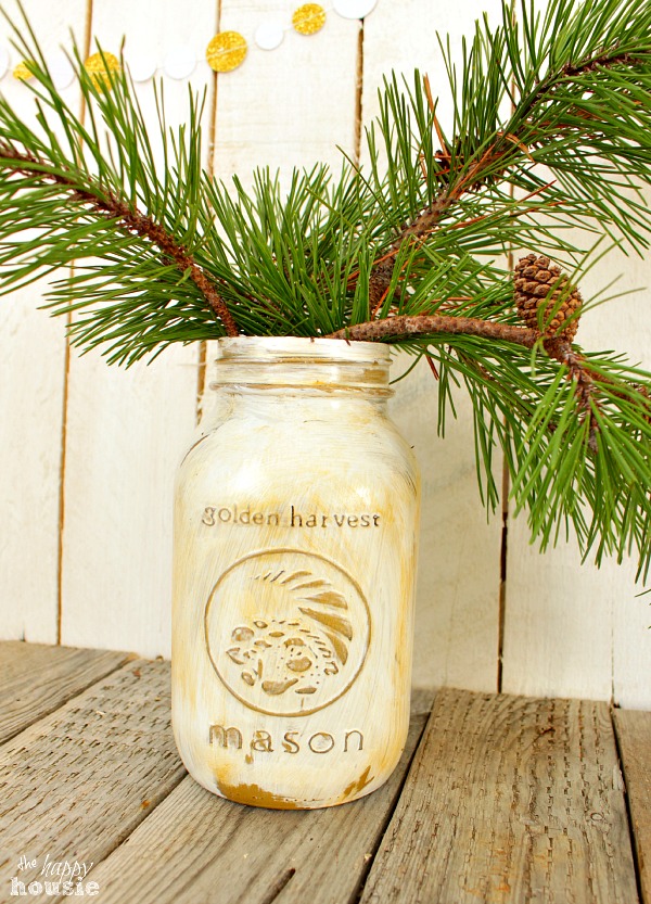 The sparkle mason jar with tree branches in it.
