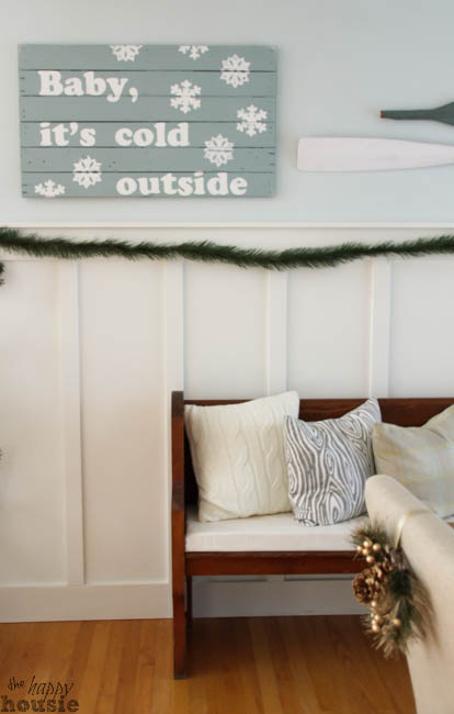 A painted sign that says Baby It's Cold Outside on the wall.