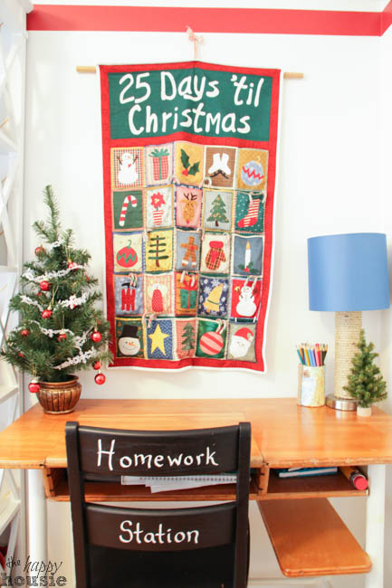 A Christmas advent calendar is on the wall above the desk.