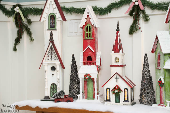 Holiday decorated churches and village are on the table.