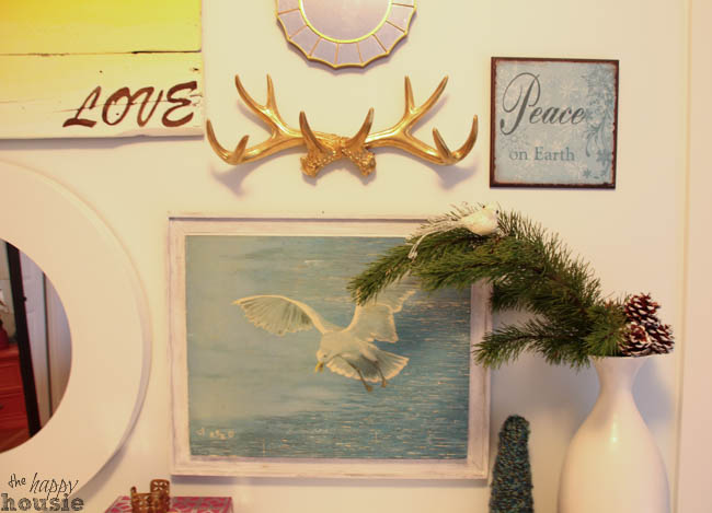 Gold antlers are above the dresser.