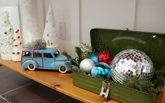 A vintage truck plus a tool box filled with shiny Christmas ornaments.