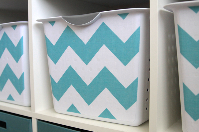 Fabric Covered Storage Bins in blue and white on shelves.