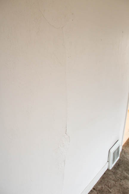 Showing cracks in the living room walls.