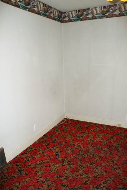 Old red carpets in the bedroom.