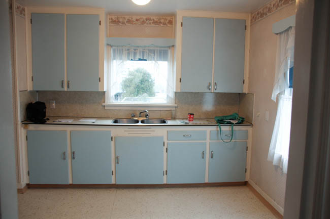 An outdated blue and white kitchen.