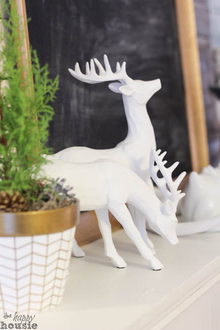 White decorative deers on the mantle.