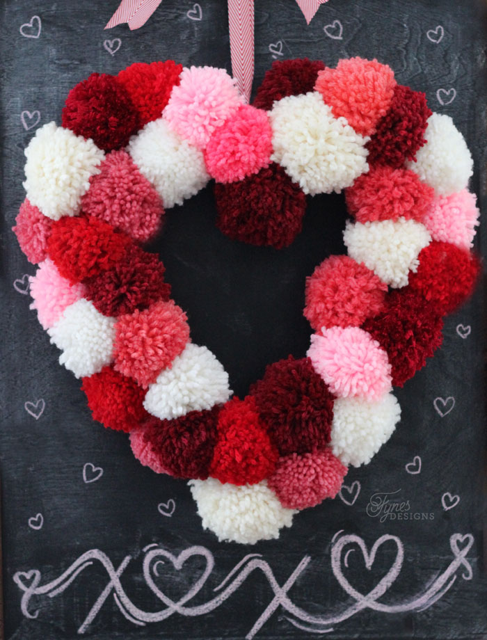 A heart wreath made of pom poms.