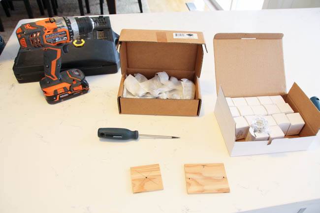 A power drill and wooden blocks on the table.