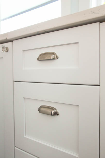The brushed steel pulls on the drawers.