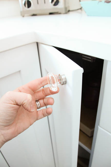 Opening up the cabinet door with the glass knob.