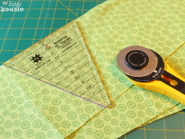 The triangle tool with the cutting tool on the fabric.