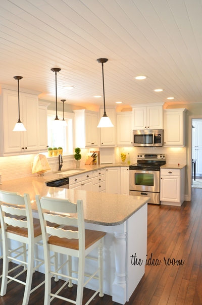 A white kitchen with a panelled ceiling.