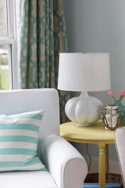 A large white lamp is on the side table.