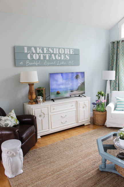 A wooden Lakeshore Cottages sign in the living room.