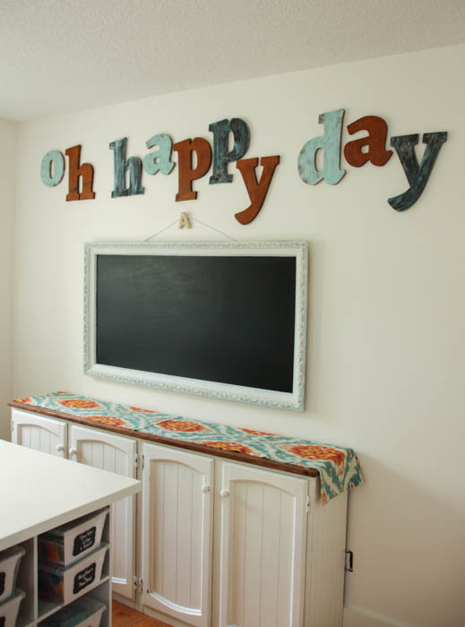 Oh happy day on the wall above the tv.