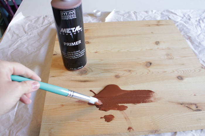 Painting primer on a piece of wood.