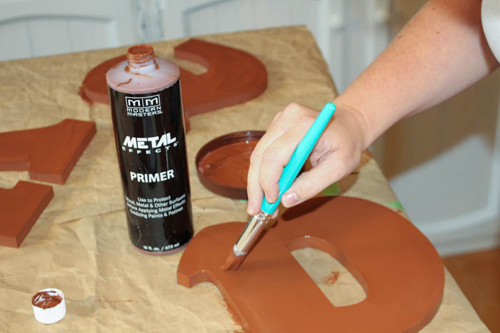 Using the special paint on the cut out letters.