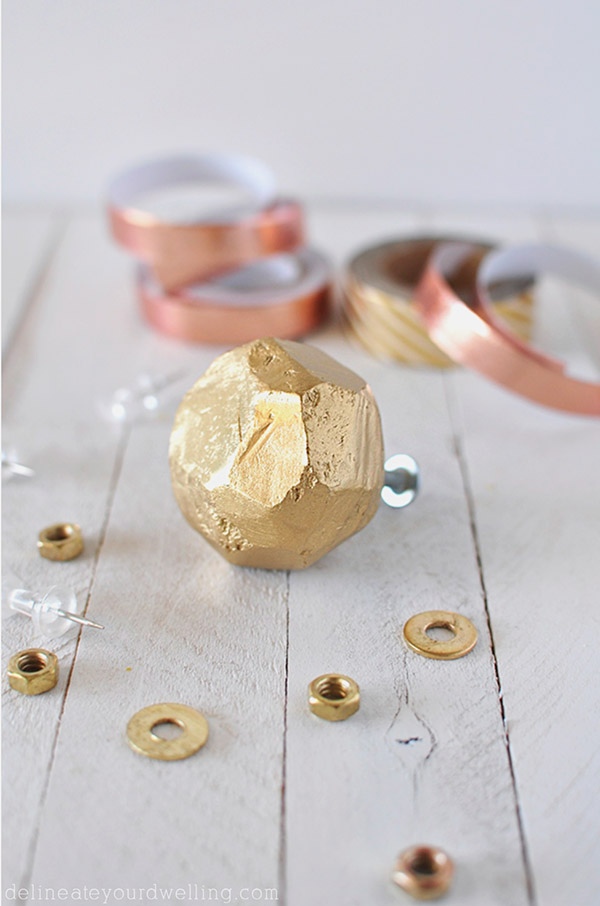 A clay knob with brushed gold look.