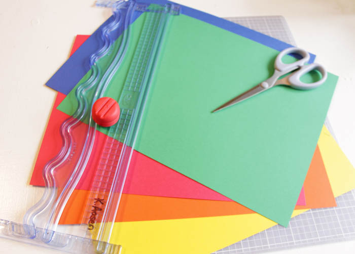 Colourful paper, scissors on the table.
