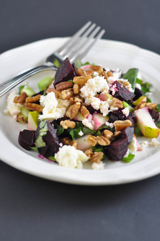 Beet-Pecan-and-Feta-Salad on a white plate with a fork on the plate.