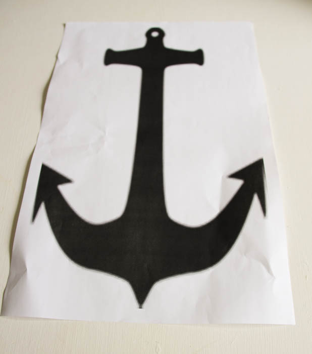A black anchor sign on white paper.