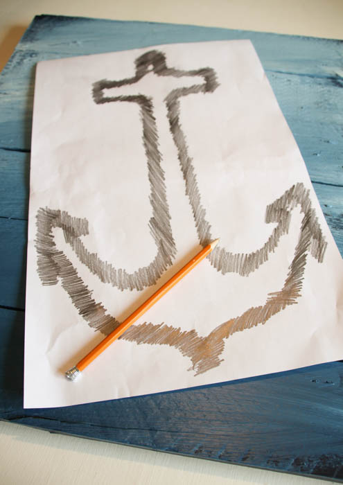The white paper, with the anchor drawn and a pencil beside it.