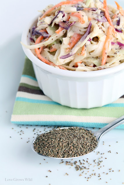 Easy-Creamy-Coleslaw filled to the top of a white bowl on the table.