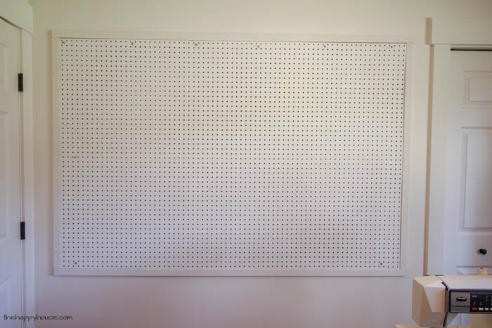 The wooden trim around the pegboard.