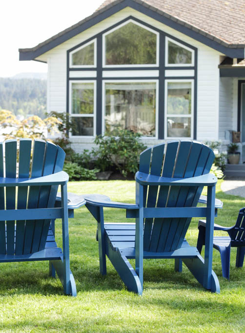 Up close picture of the blue Adirondack chairs.