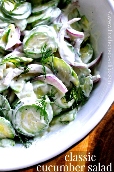 Cucumber salad with creamy dill dressing on it.