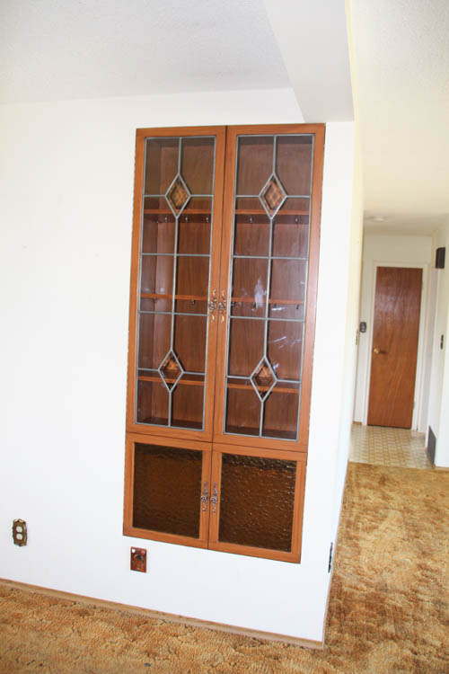 Built in cabinet with amber glass in the front.