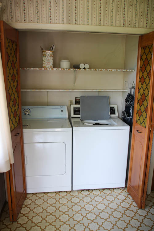 The washer and dryer behind the cabinet doors.
