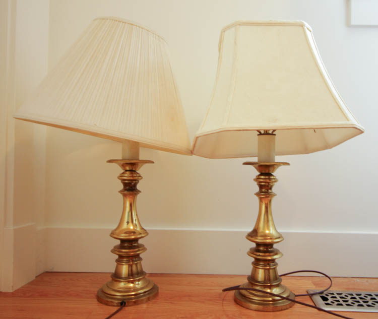 Two old lamps with worn shades.