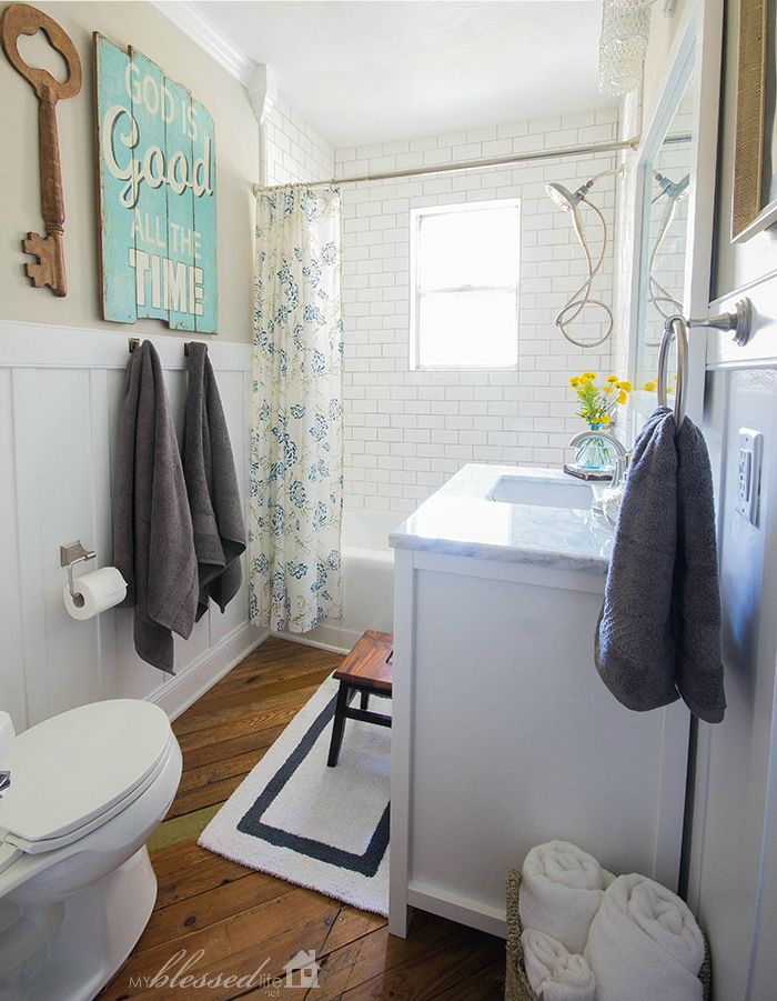 A small bathroom with panelled white wall.