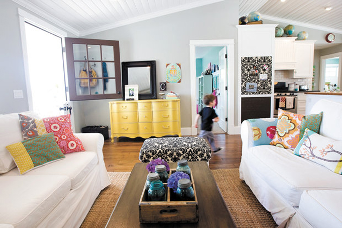 A bright yellow sideboard is in this bright living room.