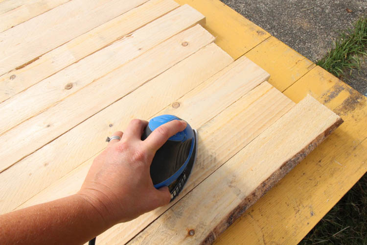 Using a palm sander to finish off before painting.