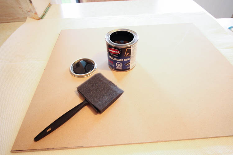 A can of chalkboard paint and a brush.
