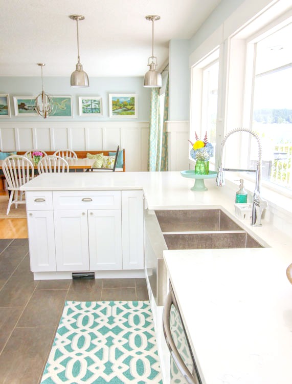 White kitchen and blue and white rug.
