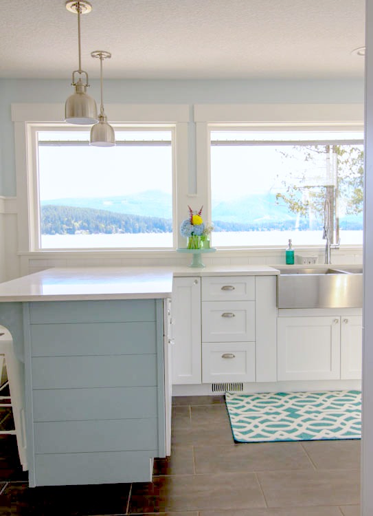 White new cabinets and an extended island with baby blue.