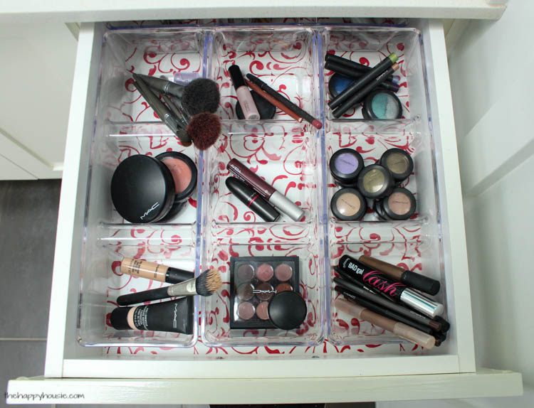 A makeup drawer with dividers in it.