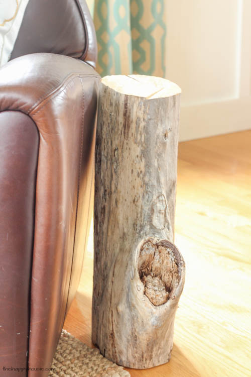 A small tree stump by the armchair.