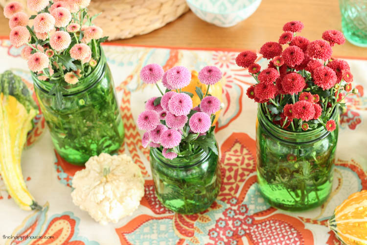 Pink, red and coral flowers on the table.