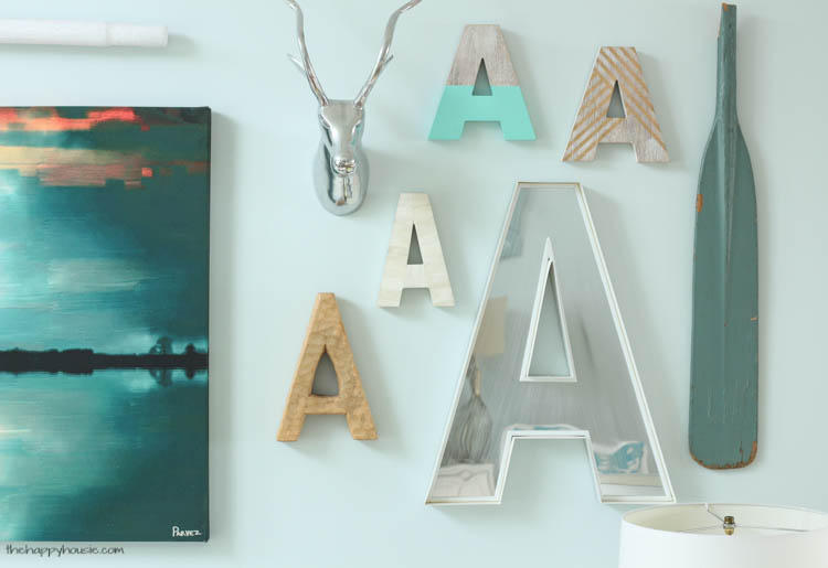 Multi coloured A's on the wall beside a turquoise paddle.