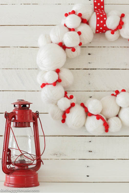 A red and white ball wreath with a red and white polka dotted ribbon.