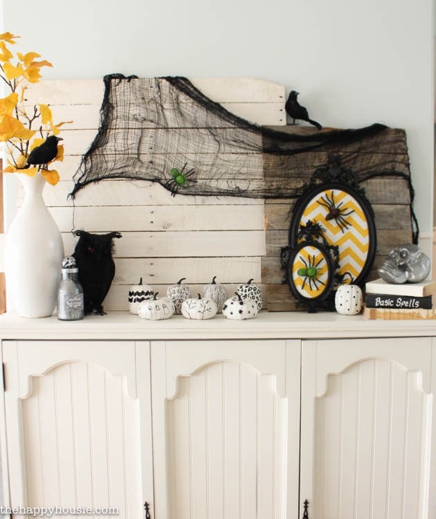 I love this fun black white and yellow Halloween Mantel with all kinds of DIY Halloween Decor projects at thehappyhousie.com-1