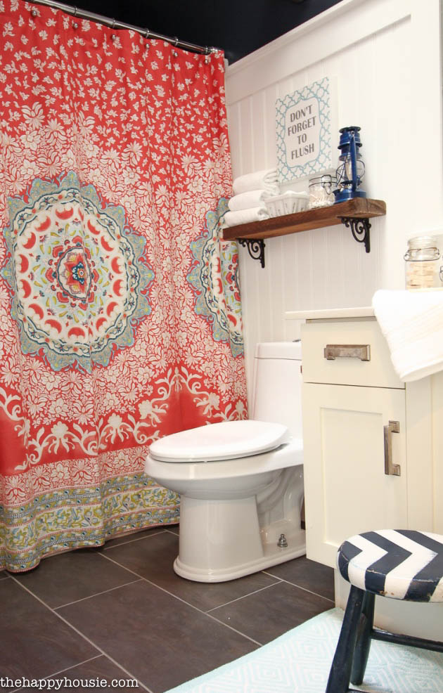 There is a striped blue and white small stool in the main bathroom reveal.