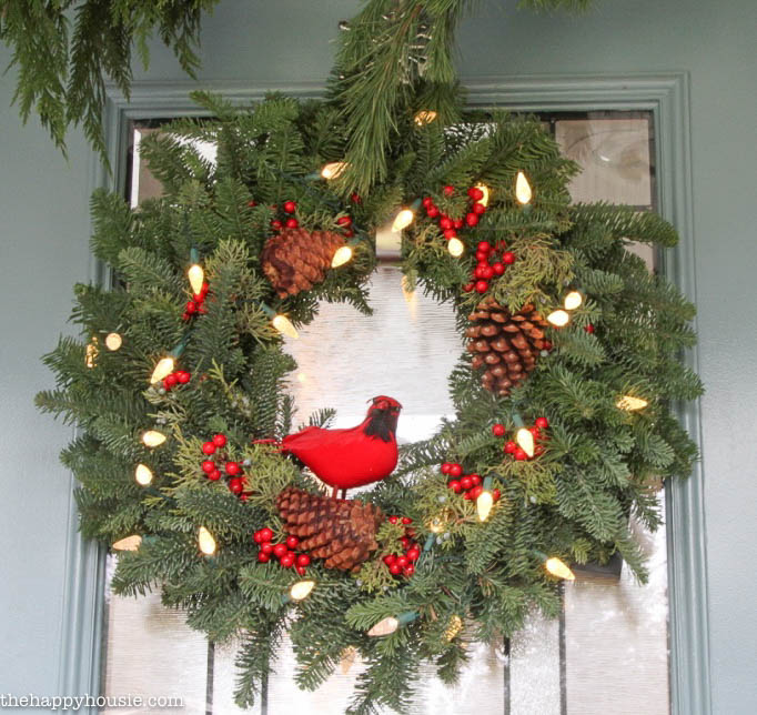 A Christmas wreath is hanging on the front door.