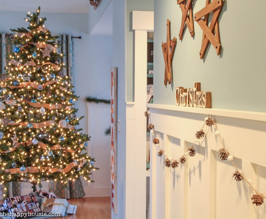 A Christmas tree is seen in the distance from the entryway.